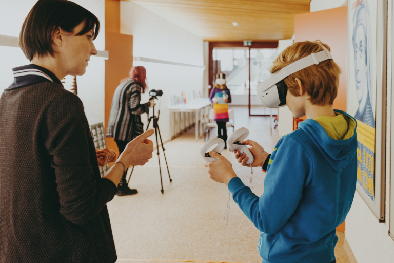 Lernberaterin erklärt Schüler Virtual Reality